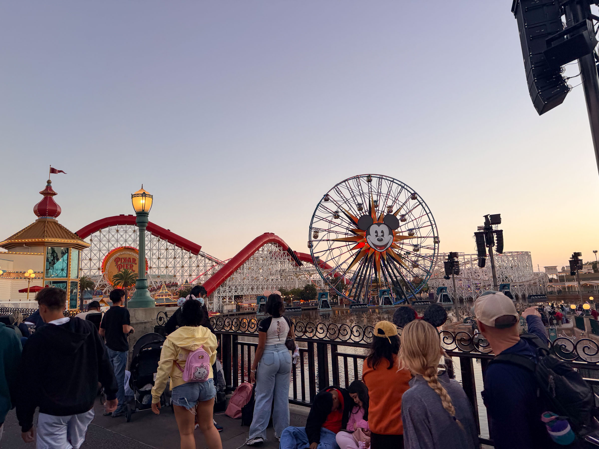 Pixar Pier at dusk with a crowd gathered for World of Color
