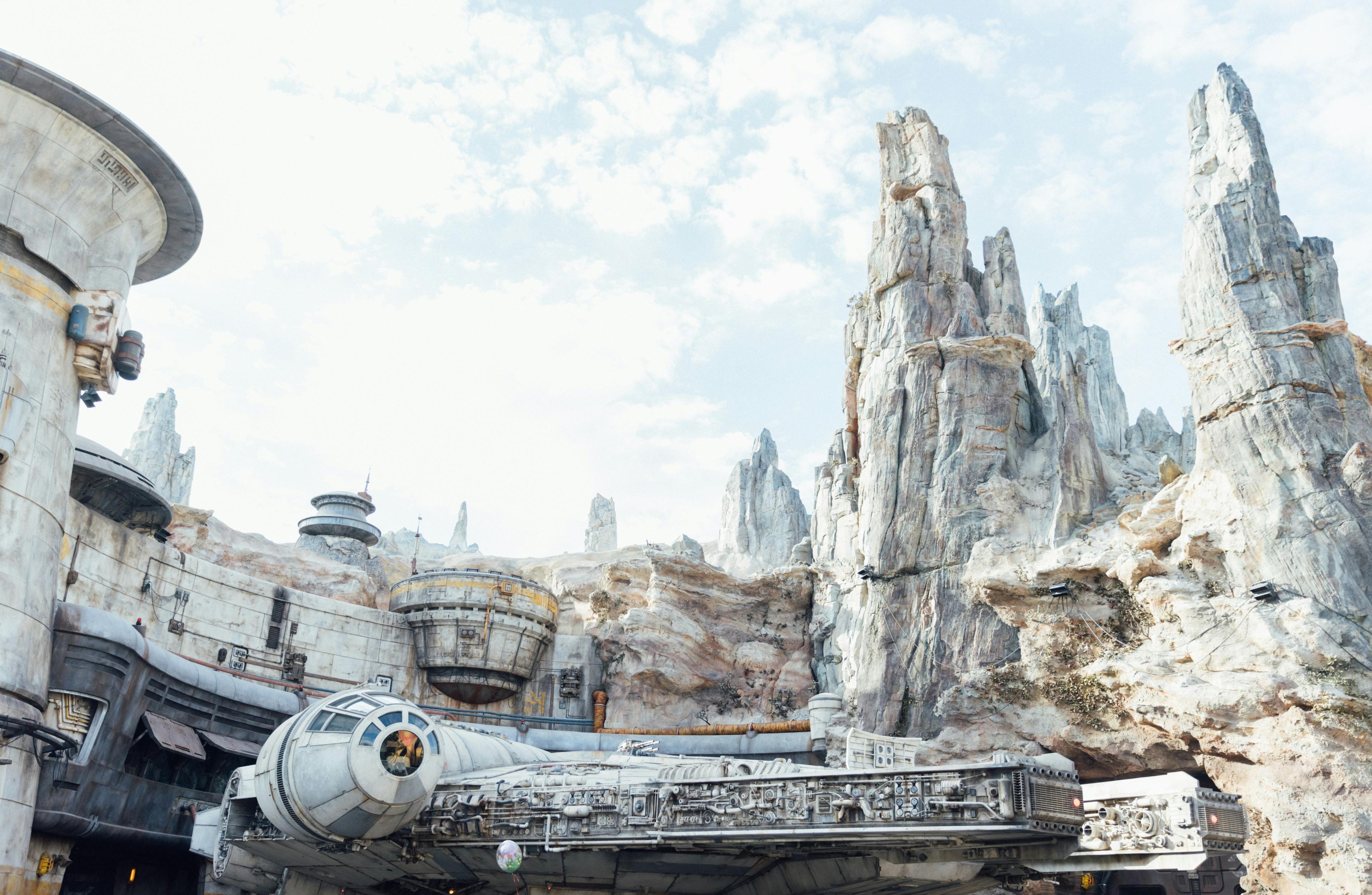 The Millennium Falcon full-scale replica in Star Wars: Galaxy's Edge at Disneyland Park on a bright day.